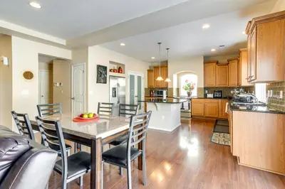 a kitchen and dining room with a table and chairs at 6 Mi to DIA Spacious Home with Backyard in Denver! in Aurora