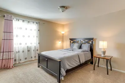 a bedroom with a bed and a window at 6 Mi to DIA Spacious Home with Backyard in Denver! in Aurora