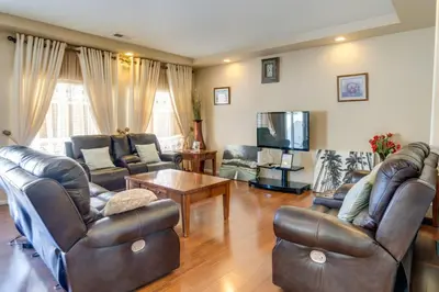 a living room with leather furniture and a tv at 6 Mi to DIA Spacious Home with Backyard in Denver! in Aurora