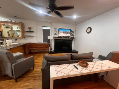 a living room with a couch and a table at Eco-Friendly Sunnyside 3 Bedroom Bungalow in Denver