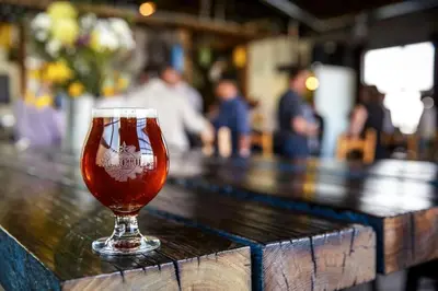 a glass of beer sitting on top of a bar at Eco-Friendly Sunnyside 3 Bedroom Bungalow in Denver