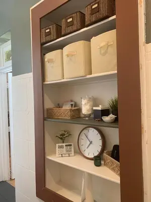 a shelf with a clock in a room at Eco-Friendly Sunnyside 3 Bedroom Bungalow in Denver