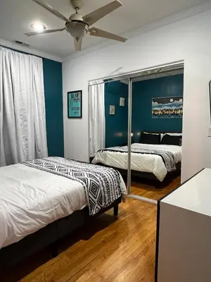 a bedroom with two beds and a ceiling fan at Eco-Friendly Sunnyside 3 Bedroom Bungalow in Denver