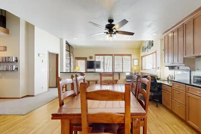 a kitchen and dining room with a table and a ceiling fan at Mountainside 120 in Granby