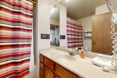 a bathroom with a sink and a mirror at Mountainside 120 in Granby