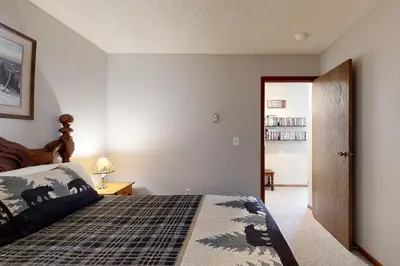 a bedroom with a bed and a book shelf at Mountainside 120 in Granby