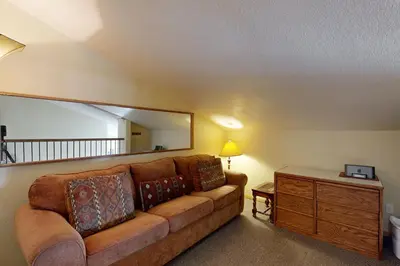 a living room with a couch and a large mirror at Mountainside 120 in Granby