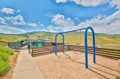 a playground with blue bars in front of a building at Mountainside 120 in Granby