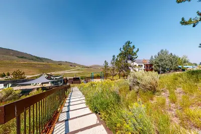 a walkway leading down a hill with a house at Mountainside 120 in Granby