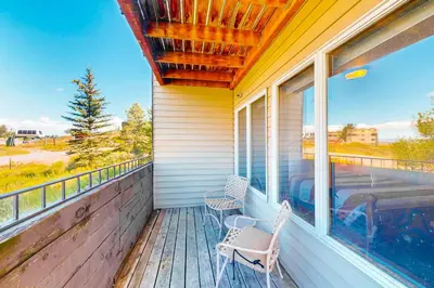 a porch with two chairs and a frisbee at Mountainside 001 in Granby