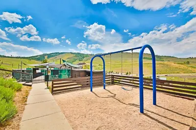 a blue bike rack in the dirt next to a fence at Mountainside 001 in Granby