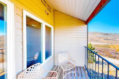 two chairs sitting on the porch of a house at Mountainside 037 in Granby