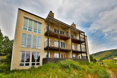 a large house on top of a hill at Mountainside 037 in Granby