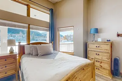 a bedroom with a bed and a large window at Lakefront Keystone Studio in Keystone