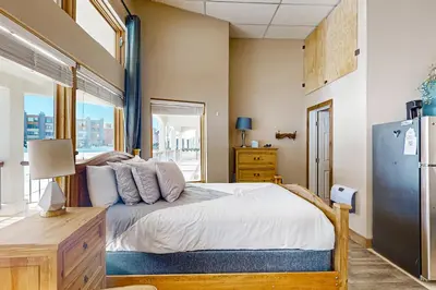 a bedroom with a large bed and a window at Lakefront Keystone Studio in Keystone