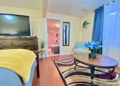 a bedroom with a bed and a table with a tv at Stylish two homes in one house 6 bedrooms 2 kitchens in Longmont
