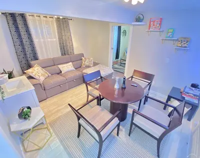 a living room with a couch and a table and chairs at Stylish two homes in one house 6 bedrooms 2 kitchens in Longmont