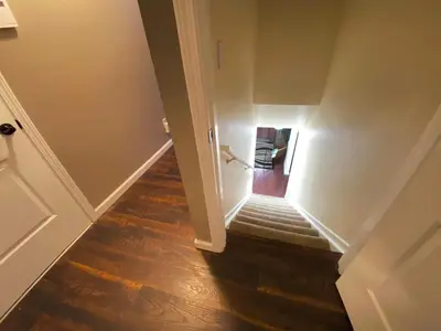 a stairway with a light at the end of a hallway at Stylish two homes in one house 6 bedrooms 2 kitchens in Longmont