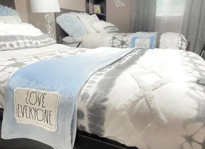 a bedroom with two beds with a love reborn sign on it at Stylish two homes in one house 6 bedrooms 2 kitchens in Longmont