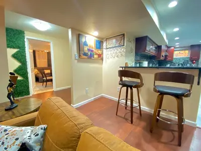 a living room with a couch and a bar at Stylish two homes in one house 6 bedrooms 2 kitchens in Longmont