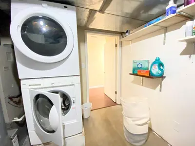 a laundry room with a washer and dryer at Stylish two homes in one house 6 bedrooms 2 kitchens in Longmont