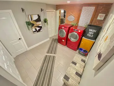 a laundry room with a washer and a washing machine at More than 100 years modern house, 3 rooms whit kids playground in Longmont