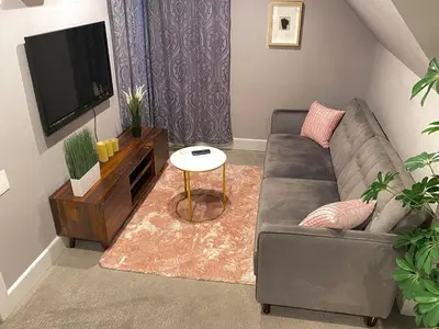 a living room with a couch and a tv at More than 100 years modern house, 3 rooms whit kids playground in Longmont