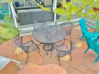 a table and four chairs sitting on a patio at More than 100 years modern house, 3 rooms whit kids playground in Longmont