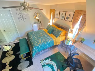 a bedroom with a bed with yellow and blue sheets at More than 100 years modern house, 3 rooms whit kids playground in Longmont