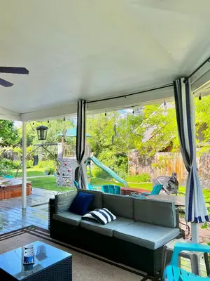 a living room with a couch and a large window at More than 100 years modern house, 3 rooms whit kids playground in Longmont
