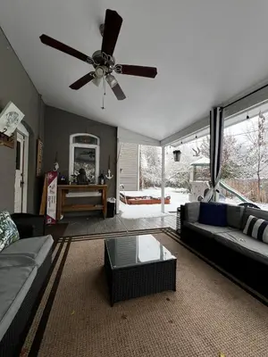 a living room with a couch and a ceiling fan at More than 100 years modern house, 3 rooms whit kids playground in Longmont