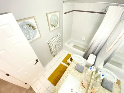 a white bathroom with a toilet and a shower at Bright, big home walking distance to Mcintosh lake in Longmont