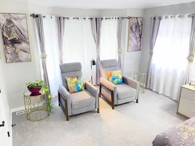 two chairs and a table in a bedroom at Bright, big home walking distance to Mcintosh lake in Longmont