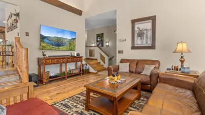 a living room with a couch and a table at 1k Pine Knolls - Estes in Estes Park