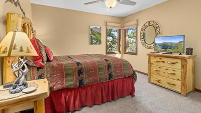 a bedroom with a bed and a desk with a lamp at 1k Pine Knolls - Estes in Estes Park
