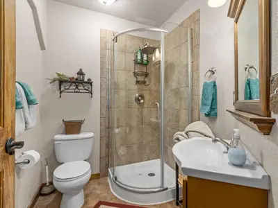 a bathroom with a shower and a toilet and a sink at 1k Pine Knolls - Estes in Estes Park