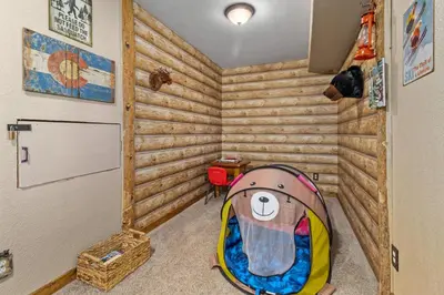 a childs room with a wooden wall at 1k Pine Knolls - Estes in Estes Park