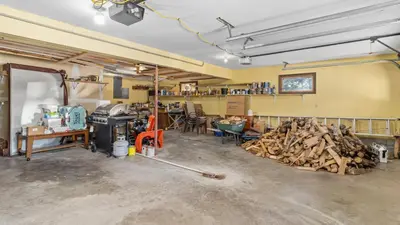 a garage with a pile of wood on the floor at 1k Pine Knolls - Estes in Estes Park