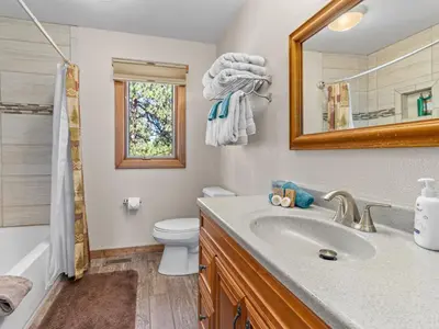 a bathroom with a sink and a toilet and a mirror at 1k Pine Knolls - Estes in Estes Park