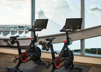 a row of exercise bikes in a room with a window at The Westin Denver International Airport in Denver