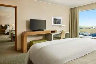 a hotel room with a bed and a desk with a television at The Westin Denver International Airport in Denver