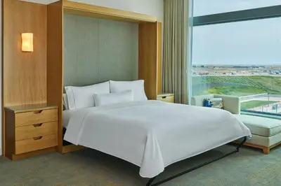 a bedroom with a large white bed and a large window at The Westin Denver International Airport in Denver