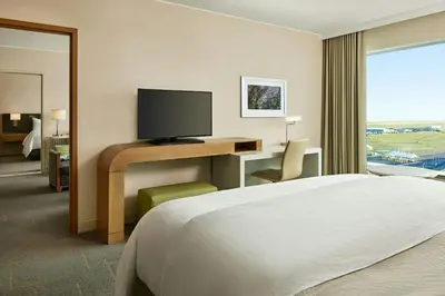 a hotel room with a bed and a desk with a television at The Westin Denver International Airport in Denver