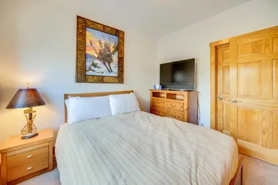a bedroom with a bed with a television and a dresser at 6 Mi to Keystone Resort Dillon Condo with Balcony in Dillon