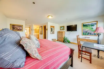 a bedroom with a bed and a desk and a television at 6 Mi to Keystone Resort Dillon Condo with Balcony in Dillon