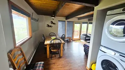 a kitchen and dining room with a table and a washing machine at Palmers Dr 1010 in Silverthorne