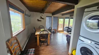 a kitchen and dining room with a table and a washing machine at Palmers Dr 1010 in Silverthorne