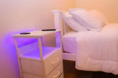 a bedroom with a bed and a night stand with a night stand at Cozy Home near Gaylord Rockies Resort & Denver Airport in Aurora