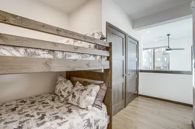 a bedroom with a bunk bed in a room at Walk to Cooper Creek Square Condo with Hot Tub! in Winter Park