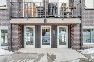 a building with four doors and a balcony at Walk to Cooper Creek Square Condo with Hot Tub! in Winter Park